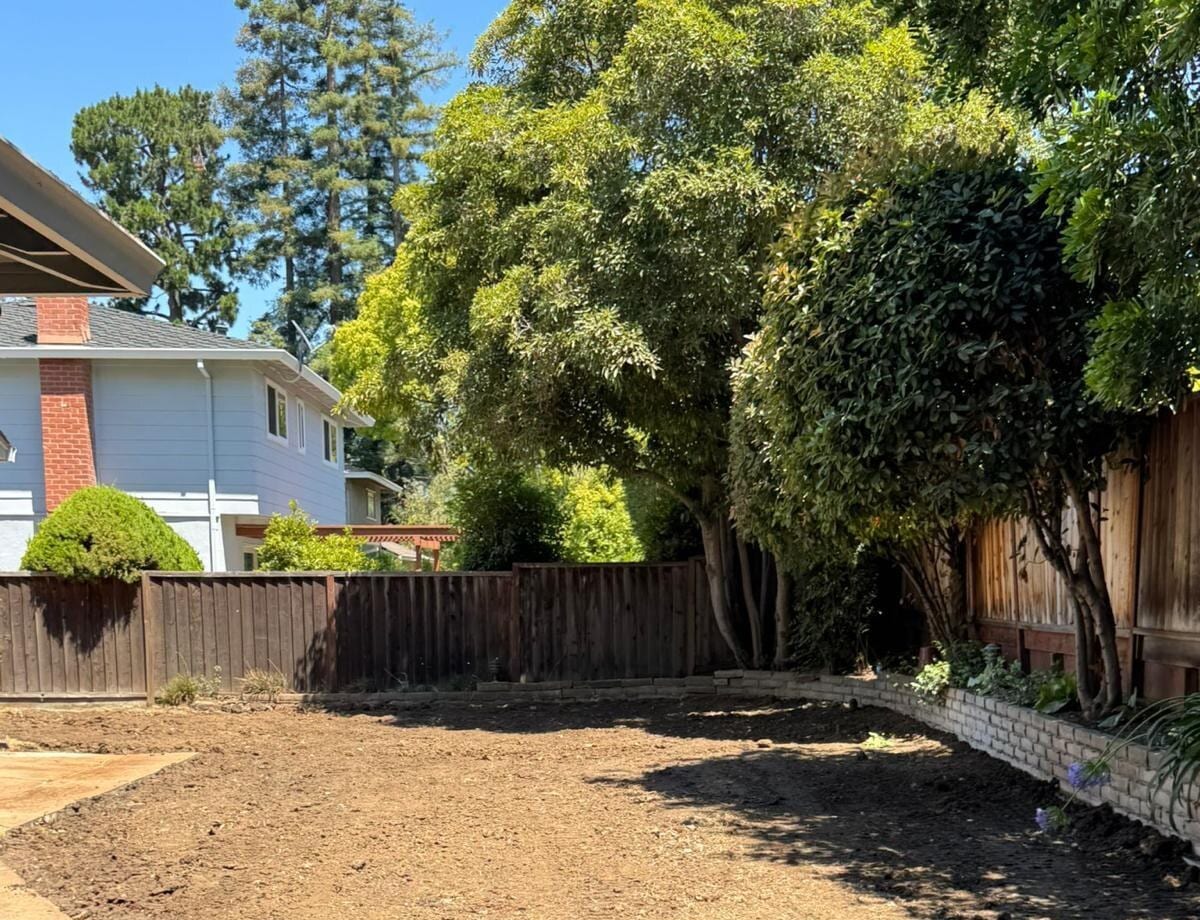 Backyard graded flat and compacted after a swimming pool was removed, ready for new construction